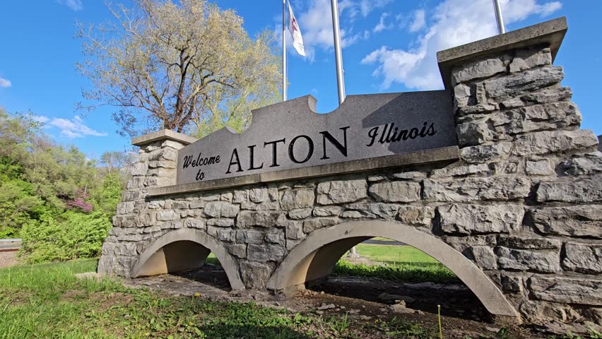 Welcome to Alton Illinois Wall Sign with Flag Poles, Close Up Low Angle Shot Along Great River Road in USA.