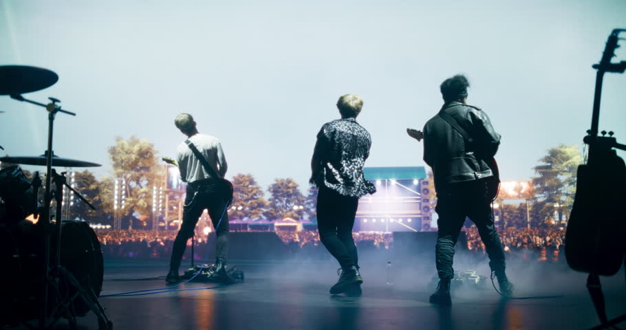 Stylish Lead Singer Performing Live on Stage with a Rock Band, Playing Alternative Rock Music at an Open Air Party. Intense Guitar Riffs at a Rock Concert on Festival Stage. Footage From the Back