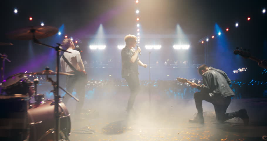 Stylish Lead Singer Performing Live on Stage with an Indie Band, Playing Alternative Music at a Rock Club. Intense Guitar Riffs at a Rock Concert on Festival Stage. Cinematic Handheld Footage