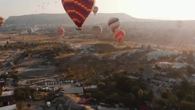 Aerial 4K Video: Spectacular View of Hot Air Balloons Soaring Over Iconic Desert Scenery
