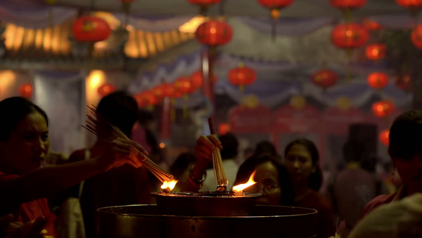 BANGKOK, THAILAND  - FEBRUARY 9, 2013: Thai people lighting incense sticks at