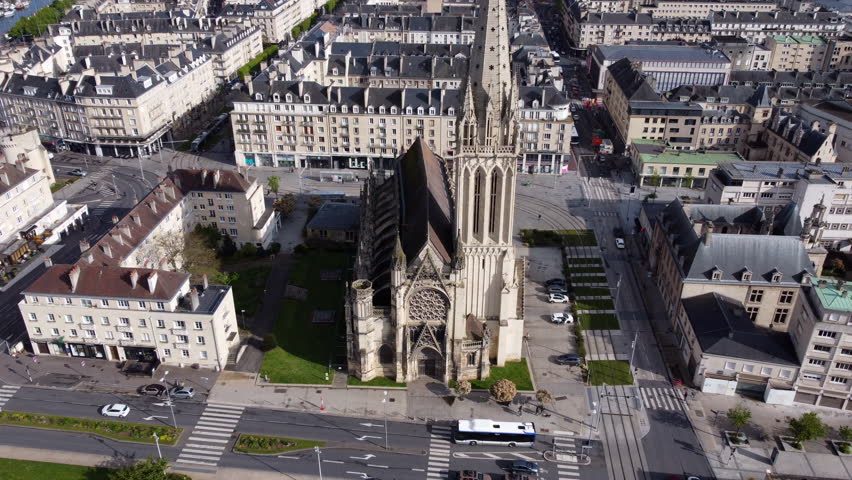Aerial flying backwards from Church of Saint Pierre in city center of Caen, France