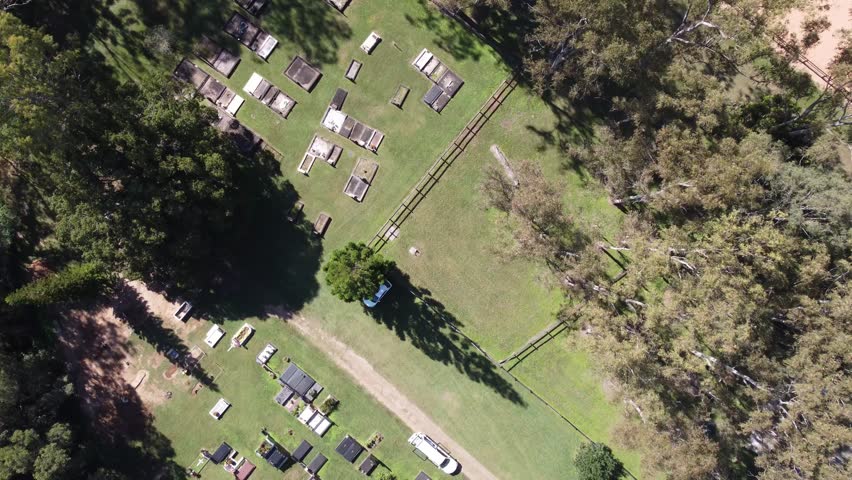 Aerial view of a small cemetery in Australia surrounded by trees and green lawn