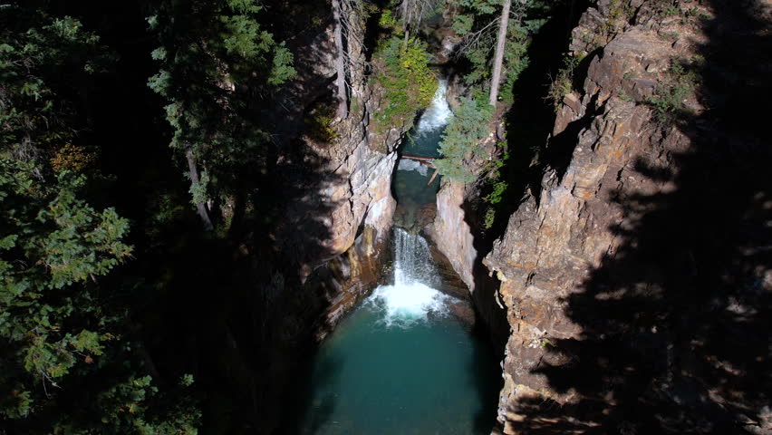 Aerial View of Cascade Creek Falls, Pristine Waterfalls and Natural Pools in Deep Canyon, Colorado USA