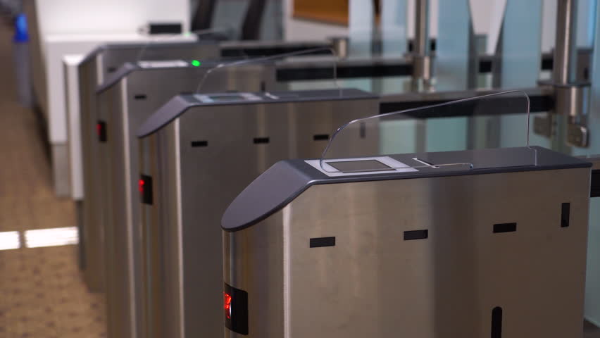 Access control systems in international airport. Validator. Checkpoint. Passenger Tapping Boarding Pass At Automated Self-boarding Gate Of An Airport.