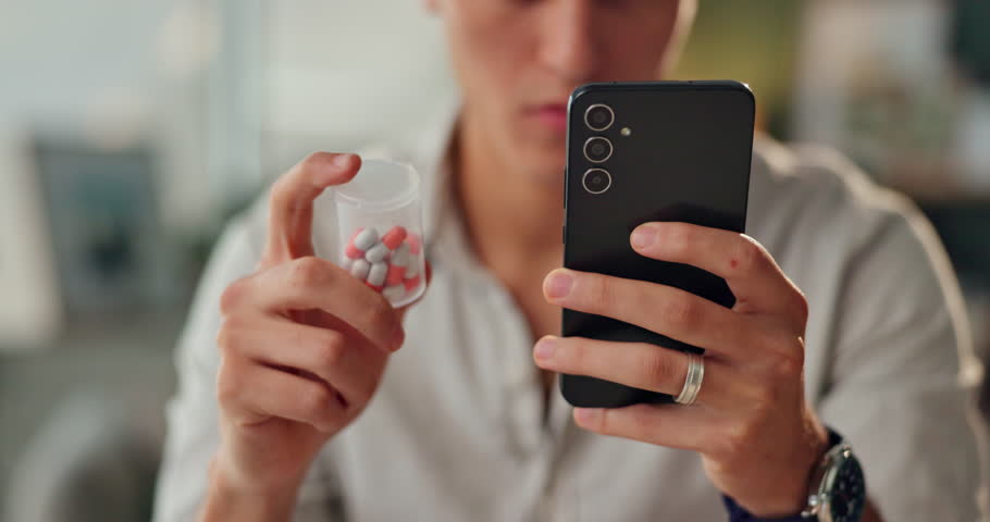 Hands, phone and pills for medicine search, health warning or person reading label in home closeup. Smartphone, medication bottle and information for drugs online, side effects or supplement benefits