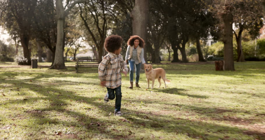 Mother, son and dog running in outdoor, bonding and exercise for pet on park trail or path. Mommy, boy and fitness for animal in nature for wellness, love and together for relationship in countryside