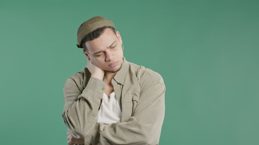 Worried thinking around hipster man on green.Confused student guy finding answer