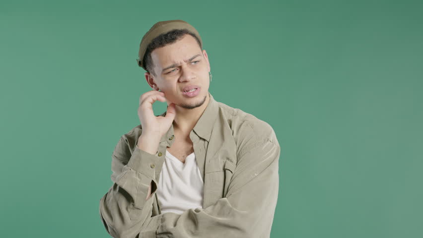 Worried thinking around hipster man on green.Confused student guy finding answer