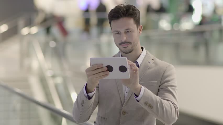 Man Immersed in the Digital World with his Fingers Across the Touchscreen