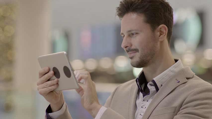 Man is Seen Tapping and Swiping on the Tablet Screen