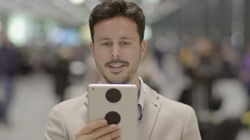 Man Immersed in the Digital World with his Fingers Across the Touchscreen