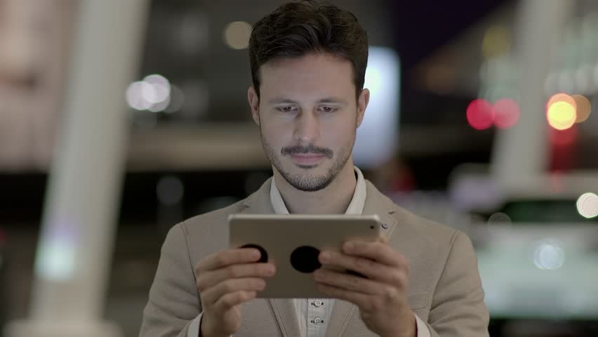 Man is Seen Tapping and Swiping on the Tablet Screen