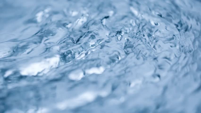 Water flow abstract. Real video, slow motion, blue frozen surface, abstract background. Macro shot. 4K Resolution