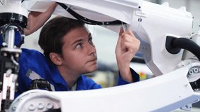 Supporting Engineer team use laptop to control and testing an Artificial Intelligent welding robotic automatic arm machine in modern factory. Automation manufacturing for industry 4.0 Technology.  - Powered by Shutterstock - Get 15% off with code: PIKWIZARD15