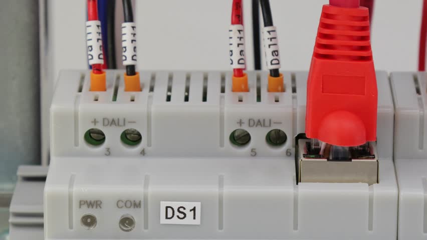 Connection of electrical units in an electrical distribution cabinet using copper mounting wires. Close-up. Soft focus.