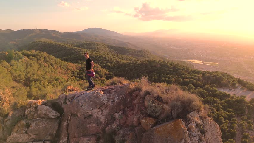 Man rock climbing aerial view of sportsman rapelling mountain in La Panocha, el Valle Murcia, Spain woman rapel down a mountain climbing a big rock