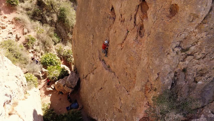 Man rock climbing aerial view of sportsman rapelling mountain in La Panocha, el Valle Murcia, Spain woman rapel down a mountain climbing a big rock