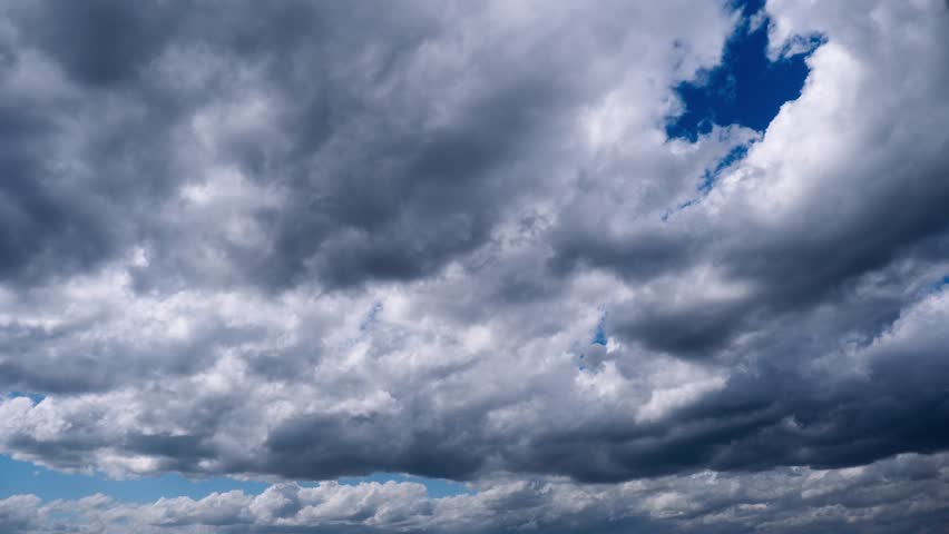 This image from a timelapse shows rapidly changing skies, with clouds morphing quickly, suitable for dynamic weather presentations.
