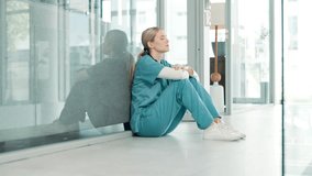 Healthcare, stress and sad nurse on floor by anxiety, burnout and headache while in emergency services. Medical care, mental health and professional worker with depression in hospital or clinic - Powered by Shutterstock - Get 15% off with code: PIKWIZARD15