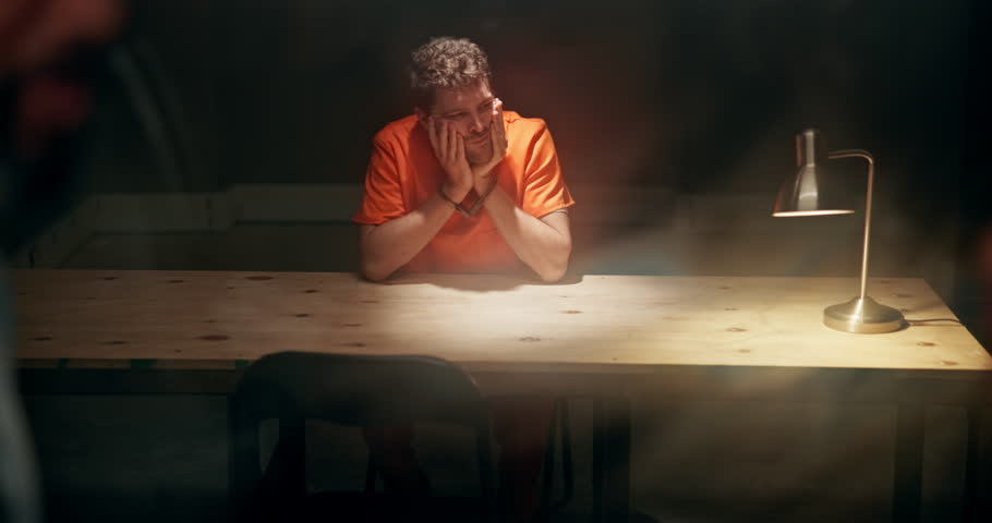 Man, interrogation room and criminal waiting, glass and detective discussion for crime with arrested convict for robbery. Planning, confession strategy and police together, people and prisoner