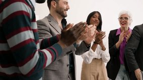 Diverse business team clapping hands in office meeting, celebrating success and teamwork, professional corporate event, positive work environment. - Powered by Shutterstock - Get 15% off with code: PIKWIZARD15