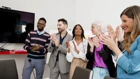 Diverse business team clapping hands in office meeting, celebrating success and teamwork, professional corporate event, positive work environment. - Powered by Shutterstock - Get 15% off with code: PIKWIZARD15