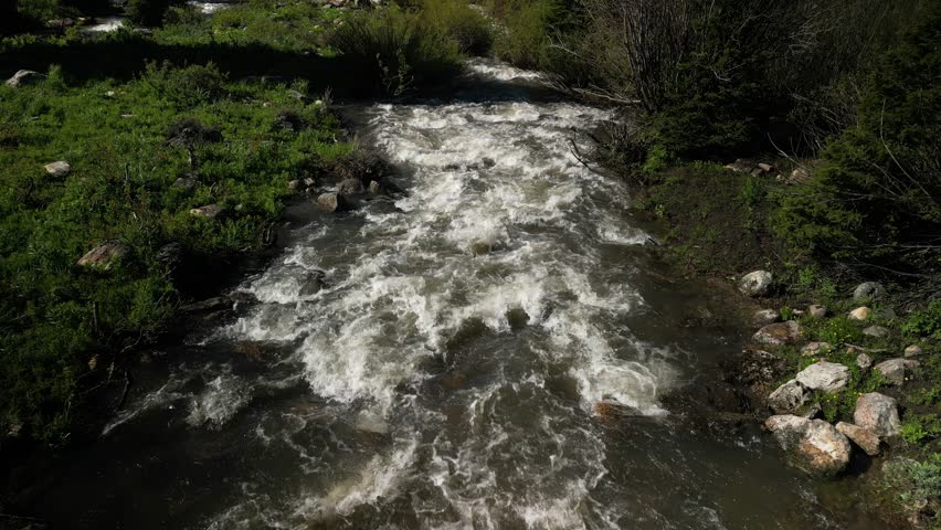 Low aerial over Logan River in Utah in springtime in Cache National Forest