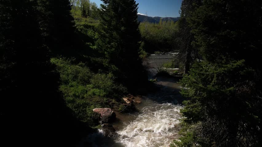 Low aerial over Logan River in Utah in springtime in Cache National Forest