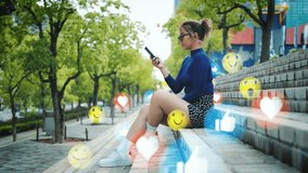 Female Social media influencer with smartphone sitting on stone staircase at the park surrounded by reaction emoticons and symbols, like, heart, laugh, thumbs up - Powered by Shutterstock - Get 15% off with code: PIKWIZARD15