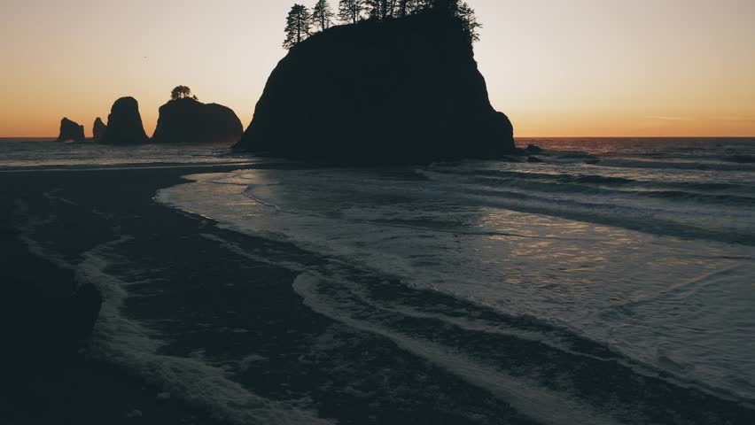 Foamy waves symmetrically hit the Rialto Beach