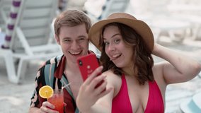 Friends vacation by the pool, sipping cocktails and taking selfies to capture happy moments - Powered by Shutterstock - Get 15% off with code: PIKWIZARD15