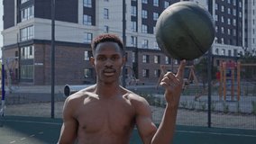 Man Spins Basketball on Finger in Street Game - Powered by Shutterstock - Get 15% off with code: PIKWIZARD15