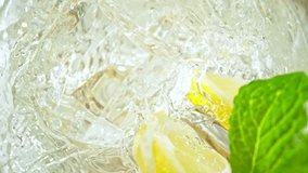 Super Slow Motion Shot of Ice Cube Falling into Glass with Lemonade at 1000fps with Camera Motion. - Powered by Shutterstock - Get 15% off with code: PIKWIZARD15