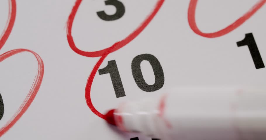Close-up shot of a calendar with the number 10 circled in red, highlighting a significant date or deadline. Ideal for concepts relating to planning, scheduling, and reminders.