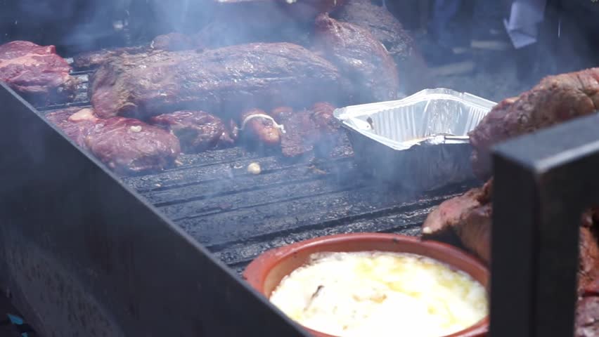 A large amount of grilled meat is prepared