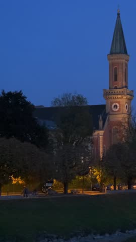 Salzburg city evening view. Cathedral, Old Town Altstadt, church, Hohensalzburg, castle illuminated at sunset. Salzach River waterfront with promenade. Salzburg, Austria