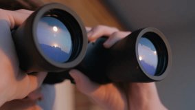 Man looking through binoculars close up - Powered by Shutterstock - Get 15% off with code: PIKWIZARD15