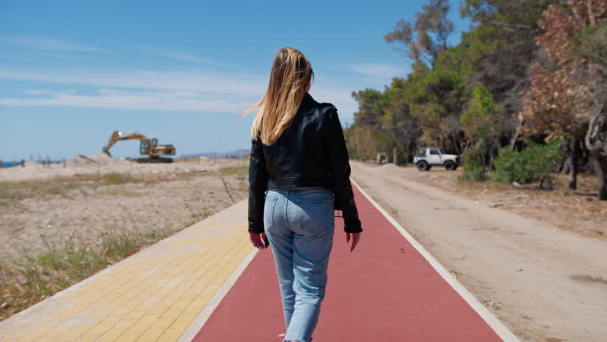 Woman Walking On A Red Path 
