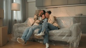 African american family funny carefree little boy kid child playing running to parents happy home owners mom dad son hugging sit on sofa together celebrate moving day relocation new apartment mortgage - Powered by Shutterstock - Get 15% off with code: PIKWIZARD15