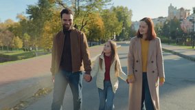 Happy Caucasian family walking at street conversation friendly talk mother father child girl daughter kid schoolgirl teen walk holding hands talking holiday in city autumn stroll together childhood - Powered by Shutterstock - Get 15% off with code: PIKWIZARD15