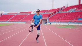 Asian para-athlete with prosthetic blades warms up body in the stadium. Attractive amputee sportsman runner prepare himself before exercise practice session for upcoming Paralympic running competition - Powered by Shutterstock - Get 15% off with code: PIKWIZARD15