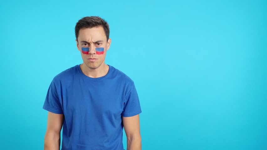 Dignified and serious man with haitian flag painted on face