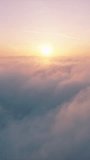 Vertical Screen: A stunning vertical video captures a breathtaking sunrise over a blanket of clouds. It is perfect for backgrounds and nature scenes, offering a serene and tranquil view of morning sky - Powered by Shutterstock - Get 15% off with code: PIKWIZARD15