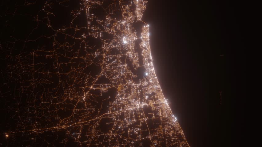 Biloxi (Mississippi, USA) top view at night. View on modern city from satellite. Camera is zooming in, rotating counterclockwise. Vertical video. The north is on the left side