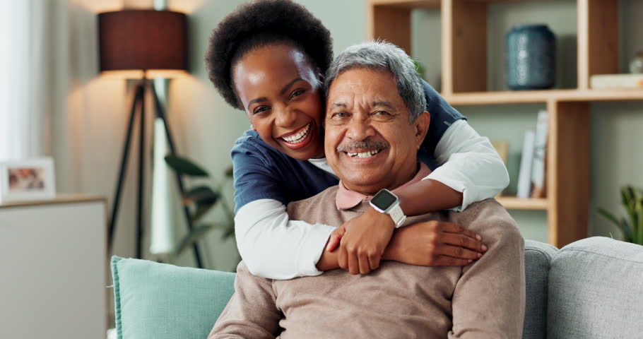 Living room, happy and nurse with hug for senior, old man and patient in home for retirement. Medical, woman and elderly male person with smile for healthcare, support and relax on sofa in house
