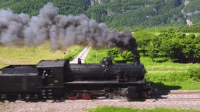 Spectacular steam train filmed in motion by a drone. Ancient locomotive that pulls carriages. train that runs on coal, snorts and makes a lot of smoke. Event where a historic means of transport passes - Powered by Shutterstock - Get 15% off with code: PIKWIZARD15
