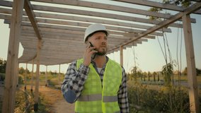Experienced Caucasian man male guy uniform businessman specialist environmental engineer calling talking mobile phone smartphone call discuss business construction plan outside rural farmland village - Powered by Shutterstock - Get 15% off with code: PIKWIZARD15
