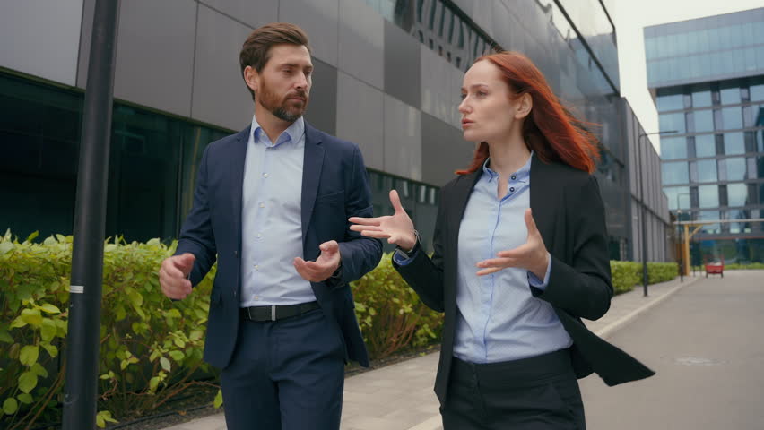 Businesspeople colleagues discussing marketing startup project ideas strategy cooperation business coworkers discuss deal entrepreneurs talking walking in city partnership businessman businesswoman