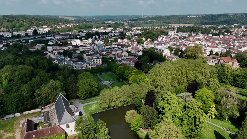 Drone view of Coulommiers city with lush green Parc des Capucins in France.